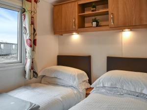 a bedroom with two beds and a window at Ashness - Uk44966 in Plumbland