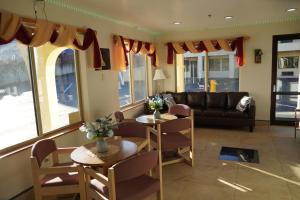 a living room with two tables and a couch at Timberland Inn & Suites in Castle Rock
