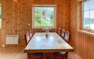 jadalnia z drewnianym stołem i krzesłami w obiekcie Amazing Home In Foldfjorden With House A Panoramic View 
