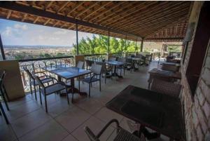 a restaurant with tables and chairs on a balcony at Loc10flats 3 Quartos - Residencial Monte Castelo in Bezerros