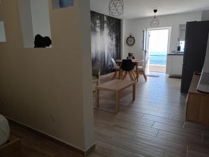 a living room with a table and a dining room at La Lunita in Valverde