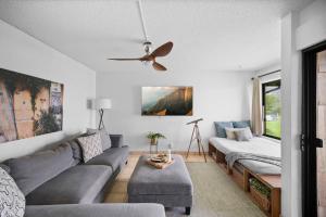 a living room with a couch and a ceiling fan at Ocean View at Sea Lodge J4 in Princeville