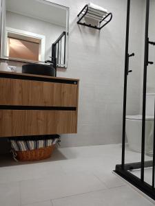 a bathroom with a sink and a mirror at La Lunita in Valverde