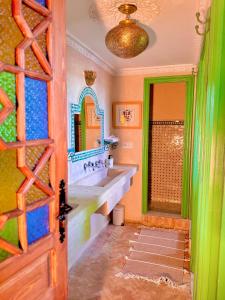 a bathroom with a sink and a mirror at Hostel Al-Qurtubi in Tangier