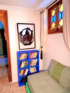 a bedroom with a blue book shelf with books at Hostel Al-Qurtubi in Tangier