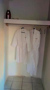 a group of white shirts hanging on a shelf at DREAM STAY Studio in Vieux Fort