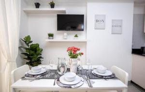 a white dining room table with white chairs and a white table cloth at Ducassi - Sol Caribe playa los corales in Punta Cana