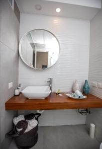 a bathroom with a sink and a mirror at Ducassi - Sol Caribe playa los corales in Punta Cana