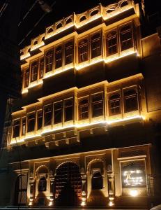 a tall building with lights on it at night at Kiran Apartment in Jaisalmer
