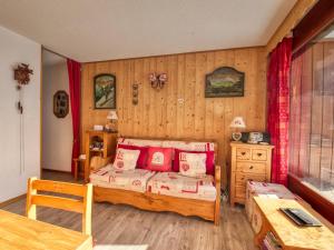 a bedroom with a bed with red pillows on it at Appartement Morillon Village, 3 pièces, 7 personnes - FR-1-642-84 in Morillon