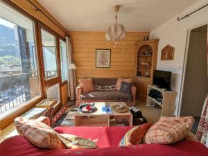 a living room with a couch and a table at Appartement La Clusaz, 2 pièces, 4 personnes - FR-1-459-215 in La Clusaz