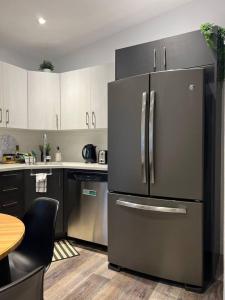 a kitchen with a large stainless steel refrigerator at Le St-Augustin in Mirabel