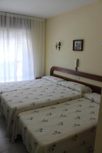 A bed or beds in a room at Hotel Arco Iris
