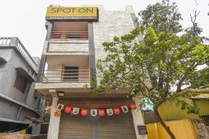 a building with a banner on the front of it at OYO Petals Residency in Nager Bazaar