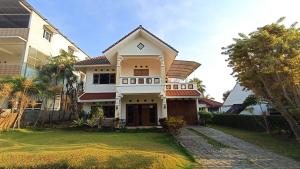 a large house with a white at Villa Ohana Batu in Batu