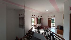 a room with a staircase and a living room at Villa Ohana Batu in Batu