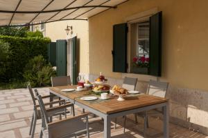 a wooden table and chairs on a patio at Villa Al Sicomoro in Grezzana