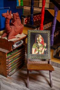 a picture of a woman on a wooden chair at Hotel Everest in Pushkar
