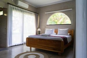 a bedroom with a large bed with a window at Mandevilla Canggu in Canggu +46 photos
