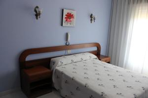 A bed or beds in a room at Hotel Arco Iris