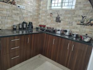 a kitchen with a counter top with pots and pans at Shree 53 1BHK in Bangalore