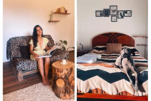 a woman sitting on a bed with a dog on it at La Casa de Damien in Urubamba