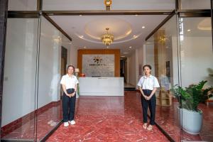 two women standing in the lobby of a building at Golden Sun Hotel Hoi An in Hoi An