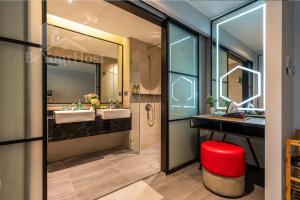 a bathroom with two sinks and a mirror at Maison 101 Dang Wangi Kuala Lumpur KLCC in Kuala Lumpur +148 photos