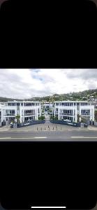 a large white building with a street in front of it at Waterfront 209 in Paihia