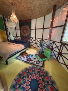 a room with two beds and a rug at Hippy Hut Koh Chang in Ko Chang