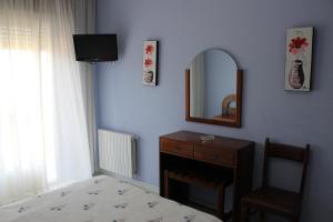 A bed or beds in a room at Hotel Arco Iris