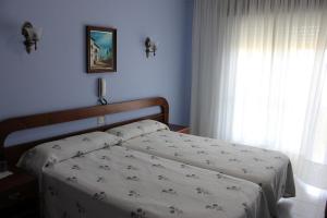 A bed or beds in a room at Hotel Arco Iris