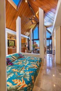Huelo的住宿－Lavish Cliff House with Ocean Views in Haiku, Maui jungle，房屋内一间卧室,配有一张大床