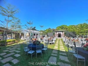 an outdoor wedding venue with white chairs and tables at PAN HOTEL AND RESORT in Abucay