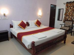 a bedroom with a large bed in a room at Royal Serene Villas in Ooty