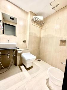a bathroom with a white toilet and a sink at HOTEL BKC PRIME - NEAR US CONSULATE in Mumbai