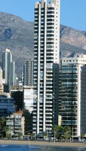 a large tall building in a city next to the ocean at Apartamentos Torre Levante - Arca Rent in Benidorm