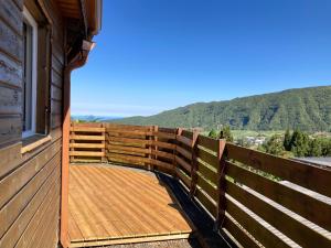 a balcony of a cabin with a view of the mountains at Le Chalet de cyprès in Saint-Louis