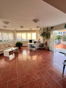 a large living room with a large tile floor at Iolkos Hotel Apartments in Kato Daratso