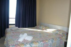 a bed with two rolls of toilet paper on it at Apartamentos Torre Levante - Arca Rent in Benidorm