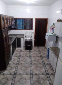 een keuken met een kookplaat in de kamer bij Casa aconchegante de praia in Itanhaém
