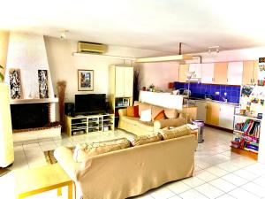 a living room with two couches and a kitchen at 2 Bedroom, Sea Side Retreat Saronida in Saronida