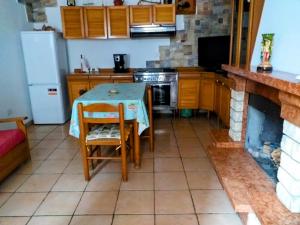 a kitchen with a table and a fireplace at La Mia Casa Sulla Collina in Valsinni