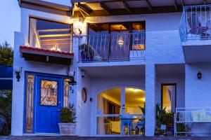 a house with a blue door and a balcony at Million Dollar Views in Hobart