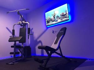 a purple room with a chair and a tv at PODLIFE in Los Angeles