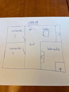 a drawing of a plan for a bathroom on a table at Happy Fisherman BnB in Aalborg