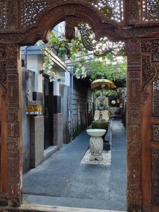 a stone archway with a fountain in a courtyard at Villa Taurus in Seminyak