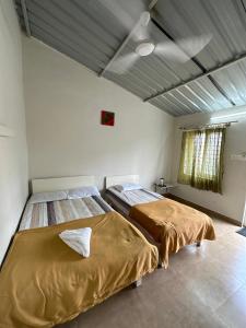 een slaapkamer met 2 bedden in een kamer bij RAC Adventure Camp by Lexstays,Near Isha Foundation in Chik Ballāpur