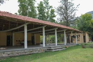 a porch of a house with a roof at RAC Adventure Camp by Lexstays,Near Isha Foundation in Chik Ballāpur