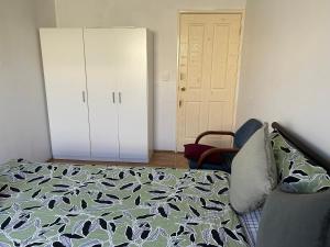 a bedroom with a bed and a closet and a door at Double room share bathroom and kitchen in Perth